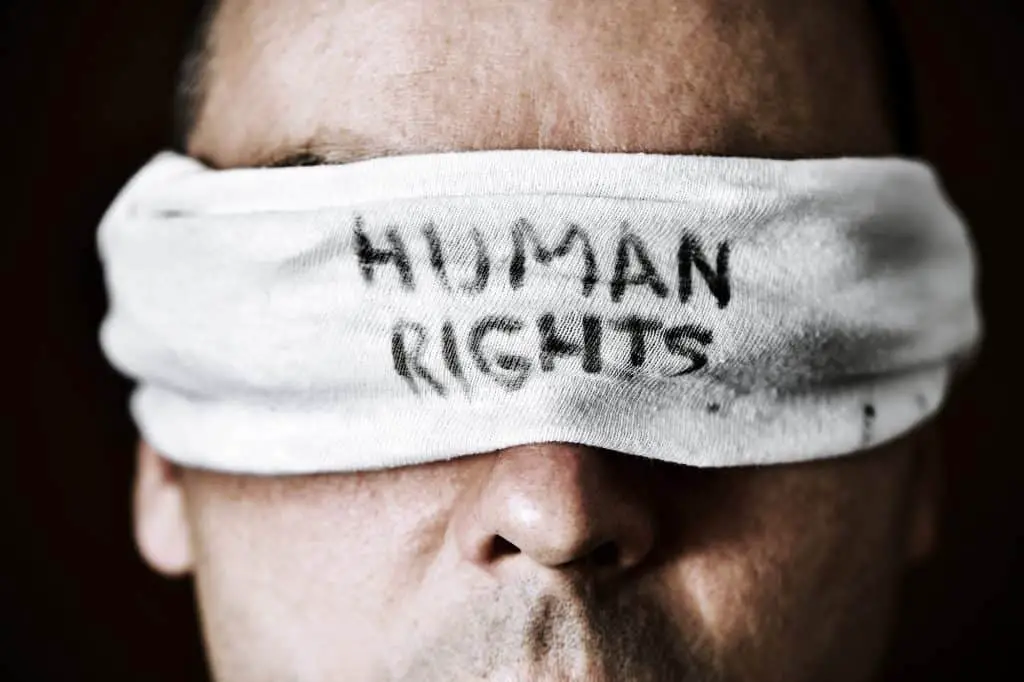 young man with a blindfold with the text human rights